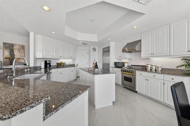 a kitchen with granite countertop stainless steel appliances and cabinets