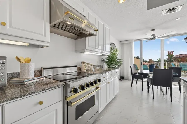 a kitchen with granite countertop a sink and a large window