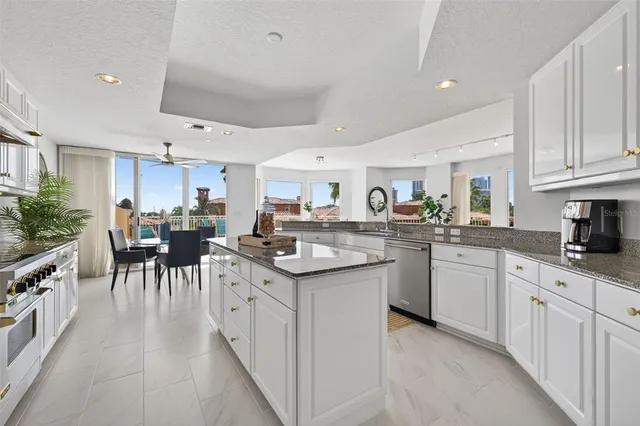 a kitchen with granite countertop a stove a sink and a granite counter tops