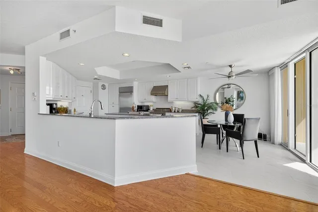a kitchen with granite countertop a sink a counter top space appliances and cabinets