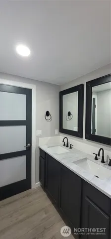 a bathroom with a double vanity sink and a mirror
