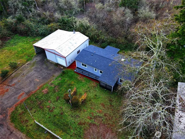an aerial view of a house with a yard