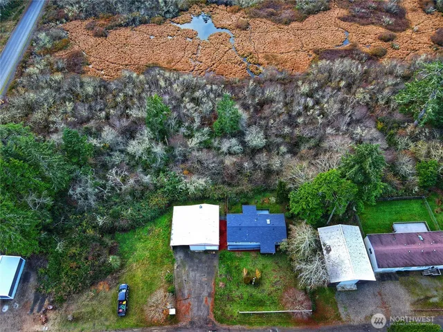 an aerial view of a house with garden space and a yard