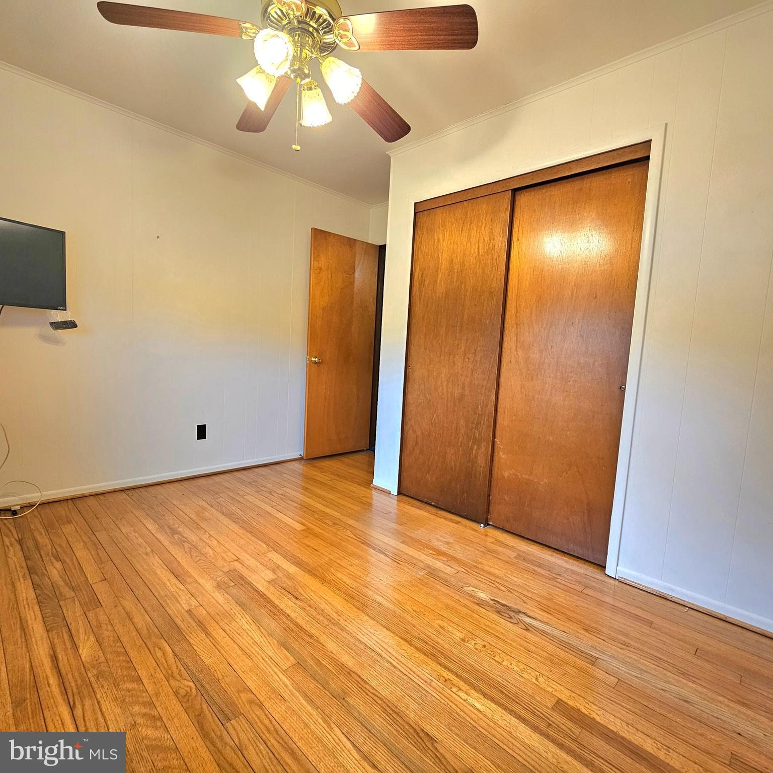 20098 Piney Point Road Callaway, MD 20620 - Photo 24 of 67 an empty room with wooden floor and fan