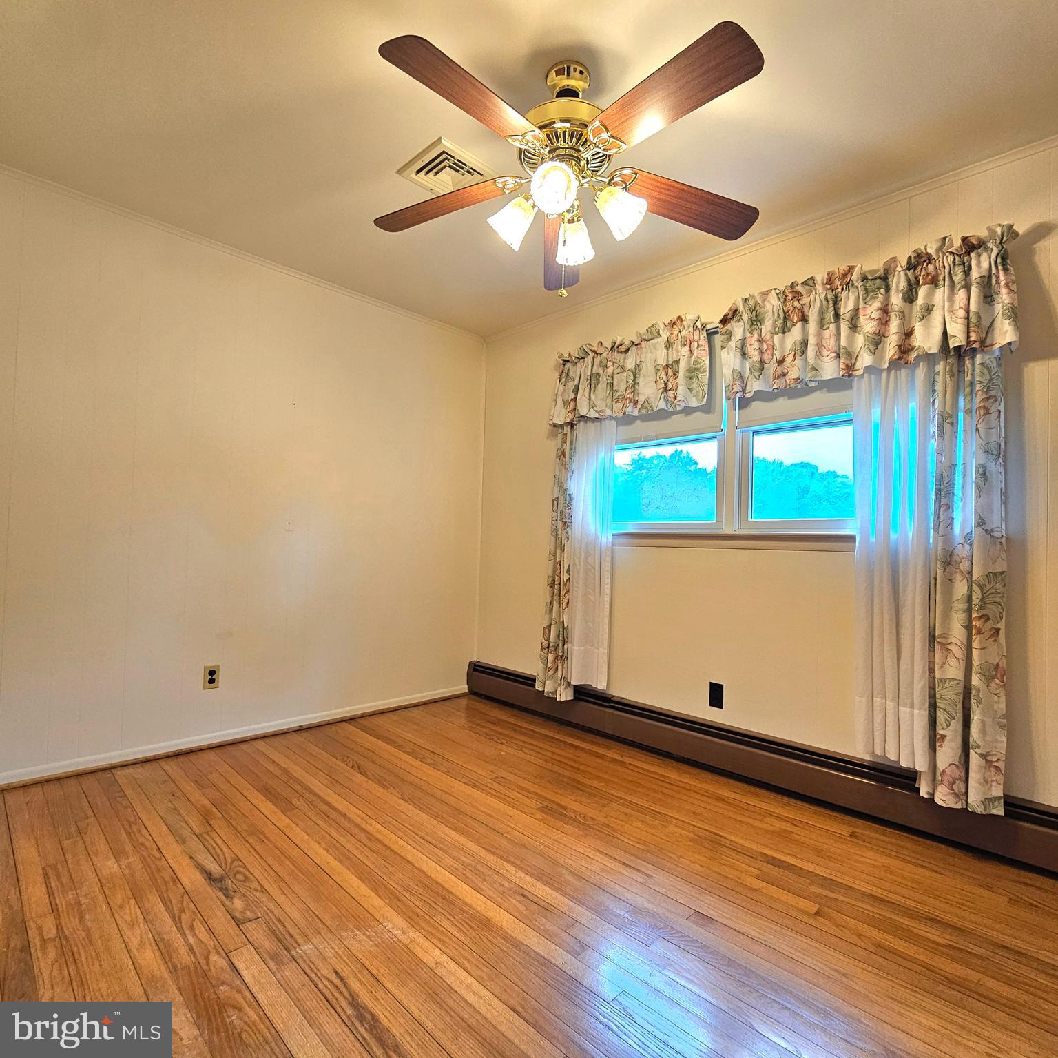 20098 Piney Point Road Callaway, MD 20620 - Photo 25 of 67 an empty room with wooden floor fan and windows