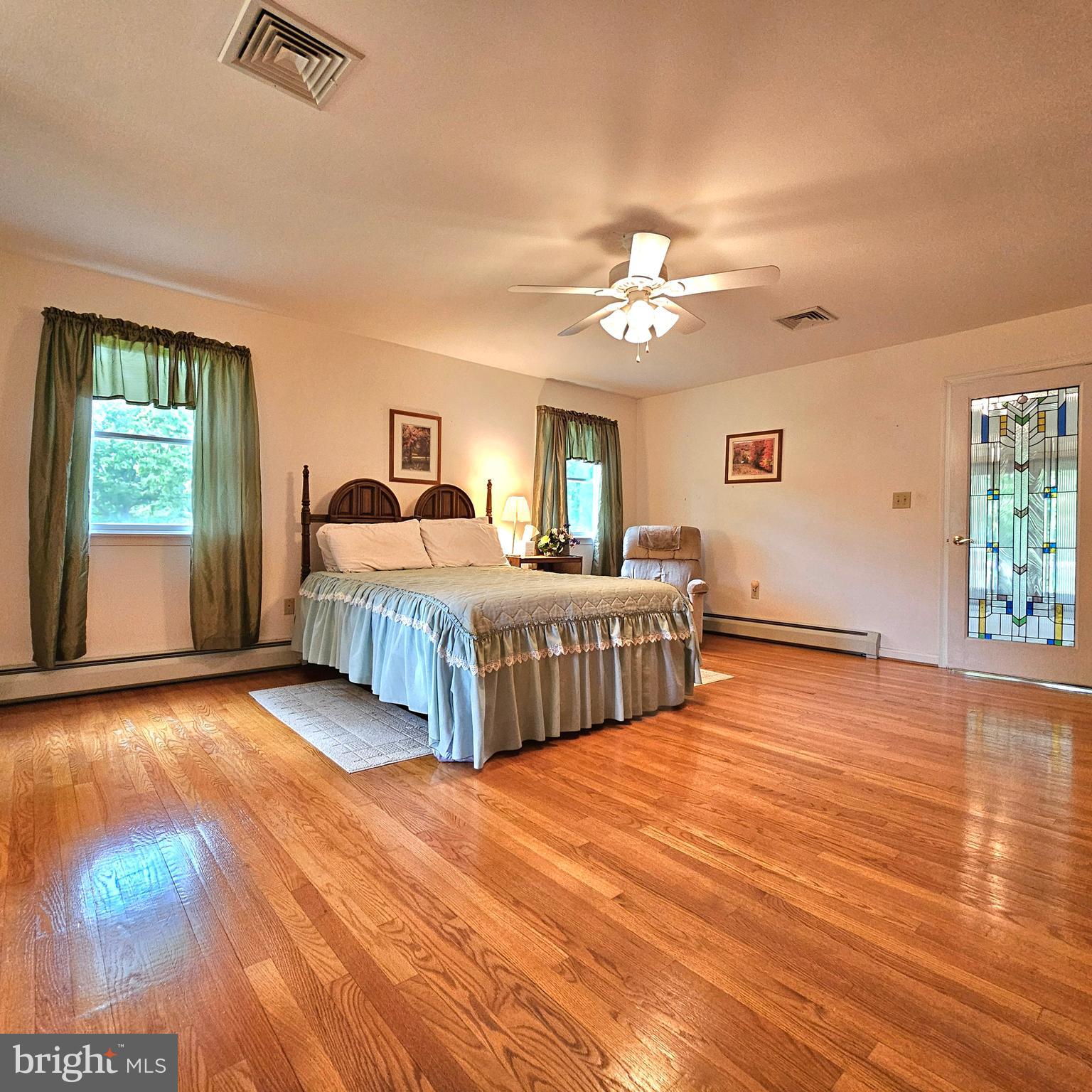 20098 Piney Point Road Callaway, MD 20620 - Photo 29 of 67 a bedroom with double bed and a chandelier