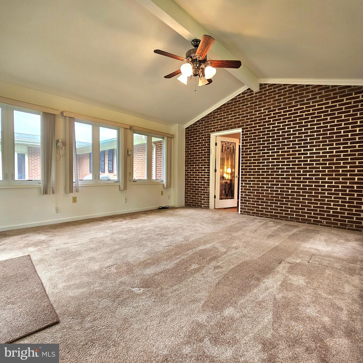 20098 Piney Point Road Callaway, MD 20620 - Photo 42 of 67 a view of an empty room with a chandelier fan and windows