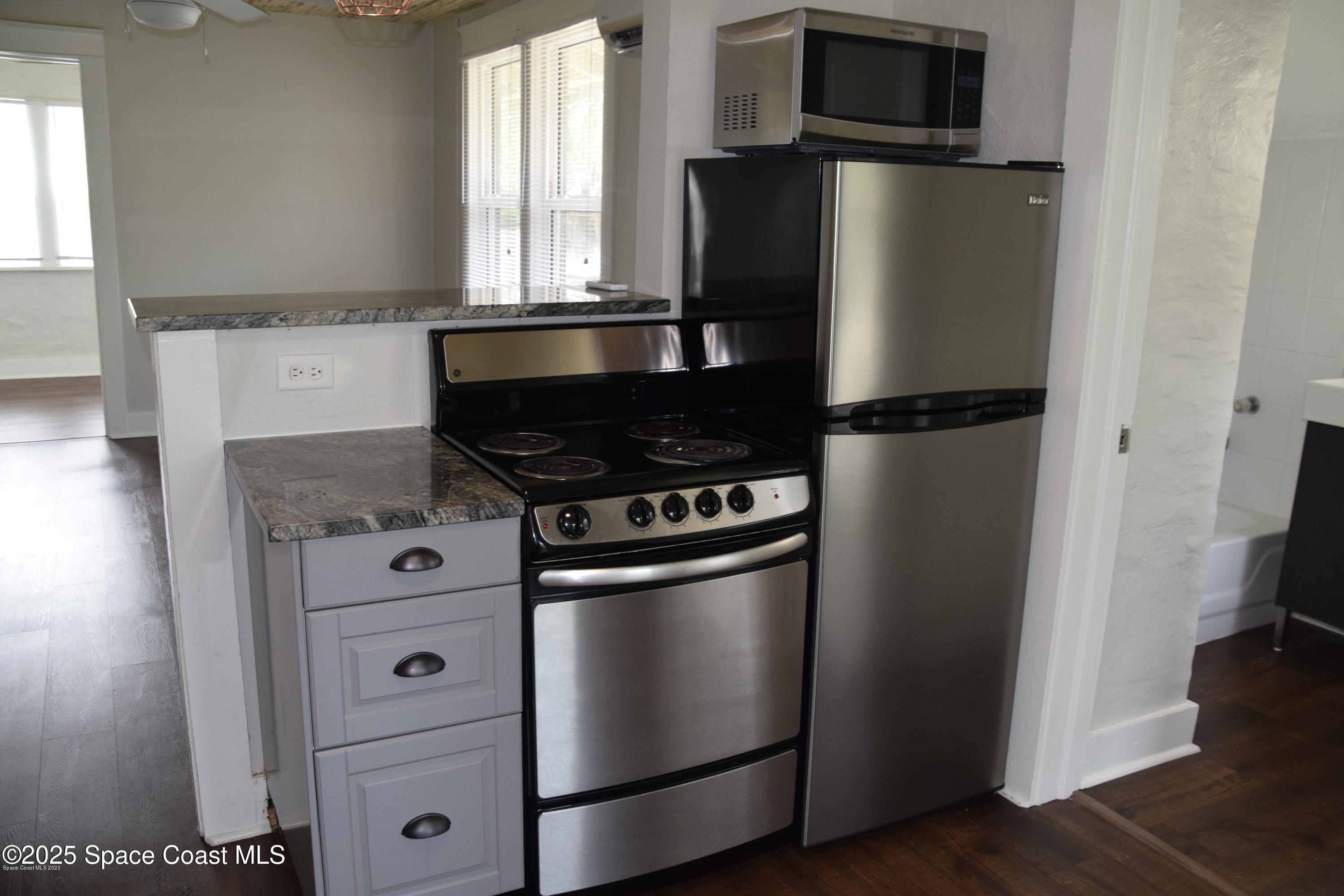 2100 Franklin Street, Unit 3 Melbourne, FL 32901 - Photo 12 of 22 a kitchen with metallic refrigerator and window