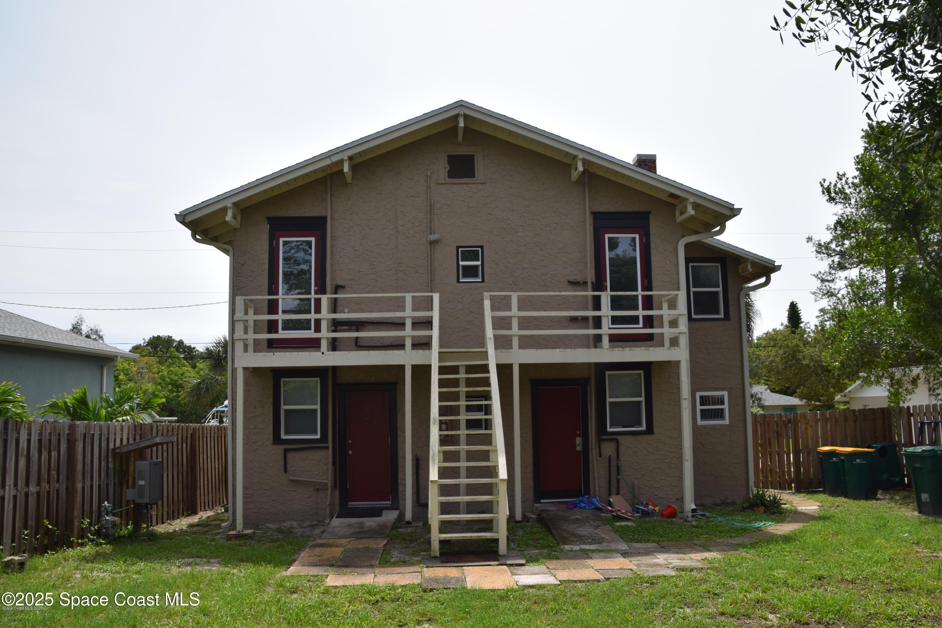 2100 Franklin Street, Unit 3 Melbourne, FL 32901 - Photo 20 of 22 a front view of a house with a yard and garage