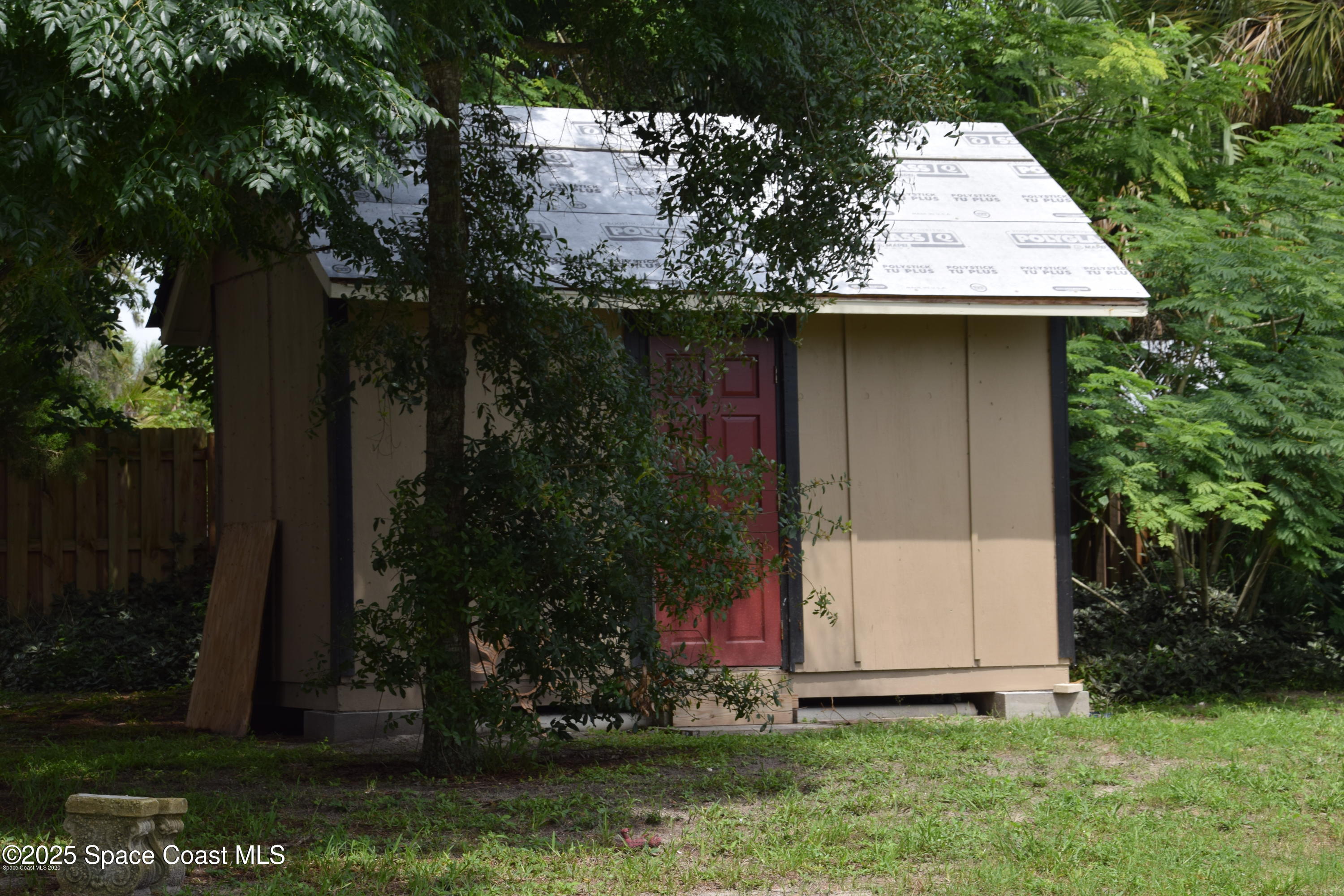 2100 Franklin Street, Unit 3 Melbourne, FL 32901 - Photo 22 of 22 a view of a wooden house with a small yard and large trees