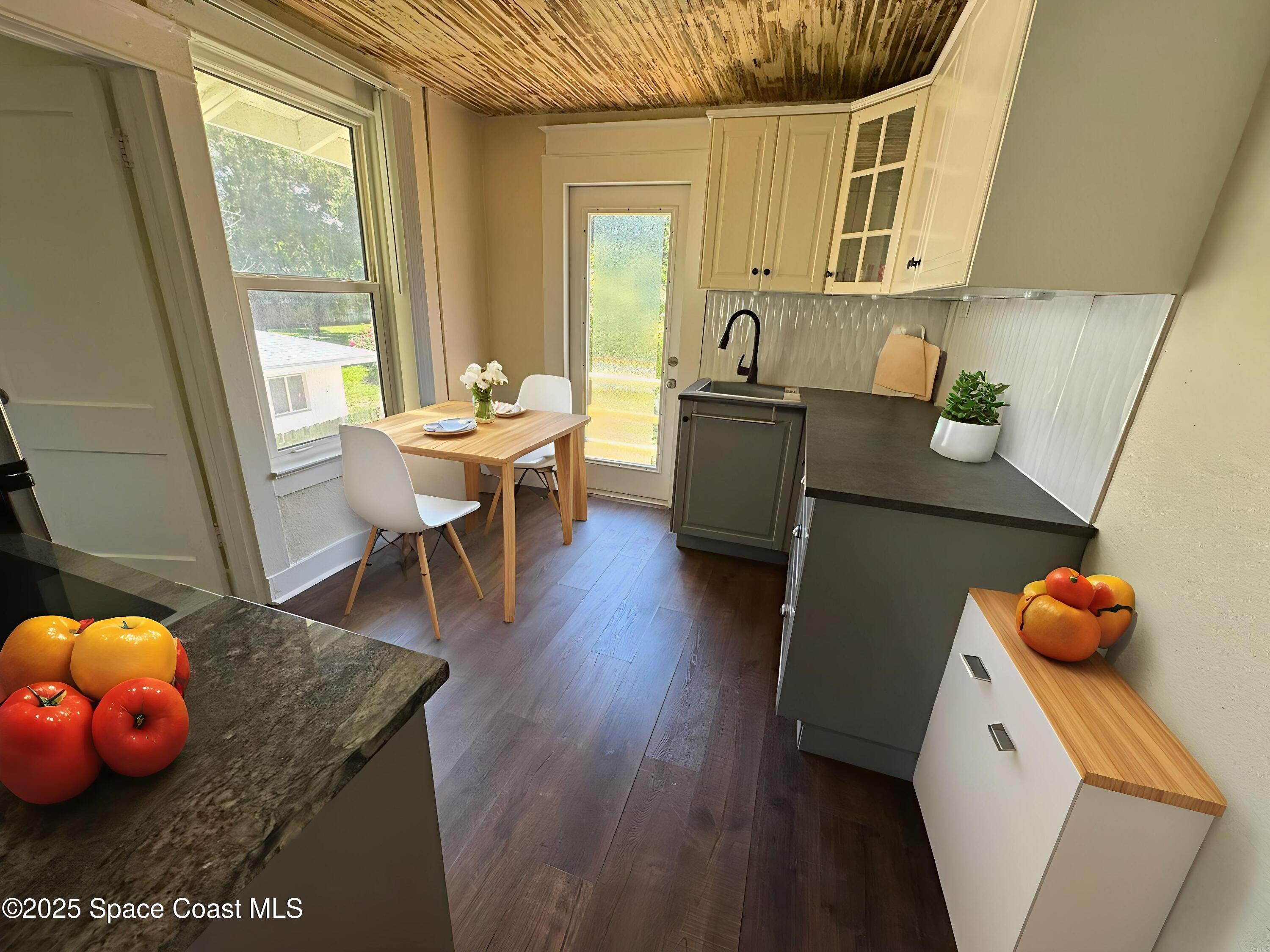 2100 Franklin Street, Unit 3 Melbourne, FL 32901 - Photo 4 of 22 a dining room with wooden floor and furniture