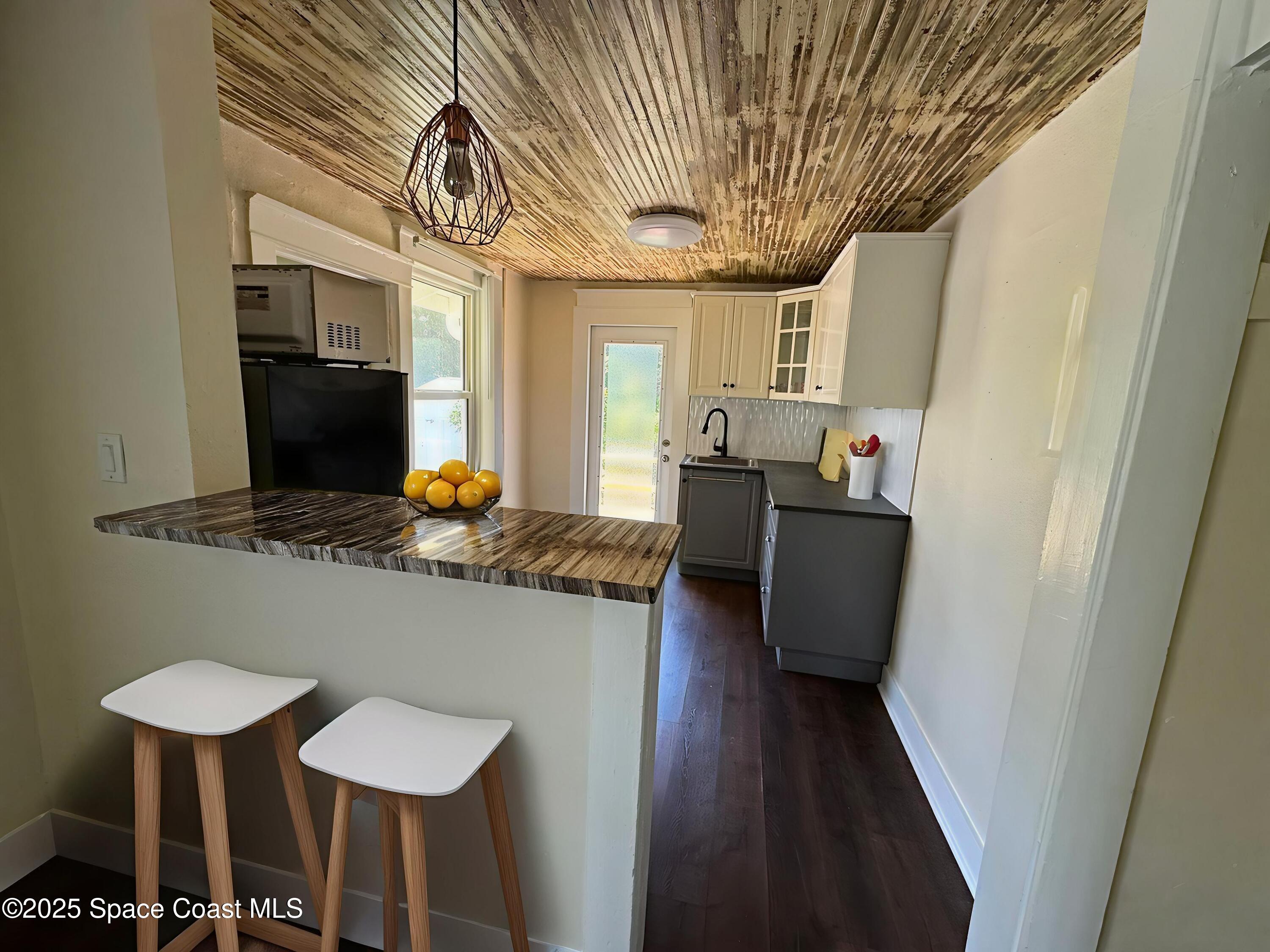 2100 Franklin Street, Unit 3 Melbourne, FL 32901 - Photo 5 of 22 a dining room with furniture and wooden floor
