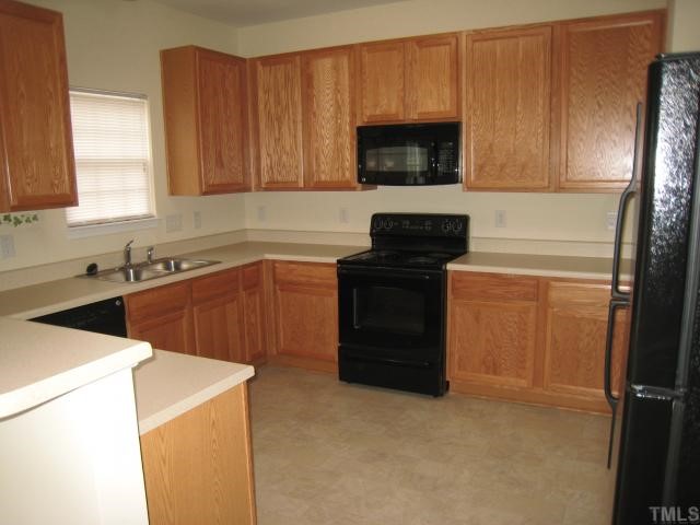 3542 Oneonta Avenue Raleigh, NC 27604 - Photo 5 of 6 a kitchen with a sink and a microwave