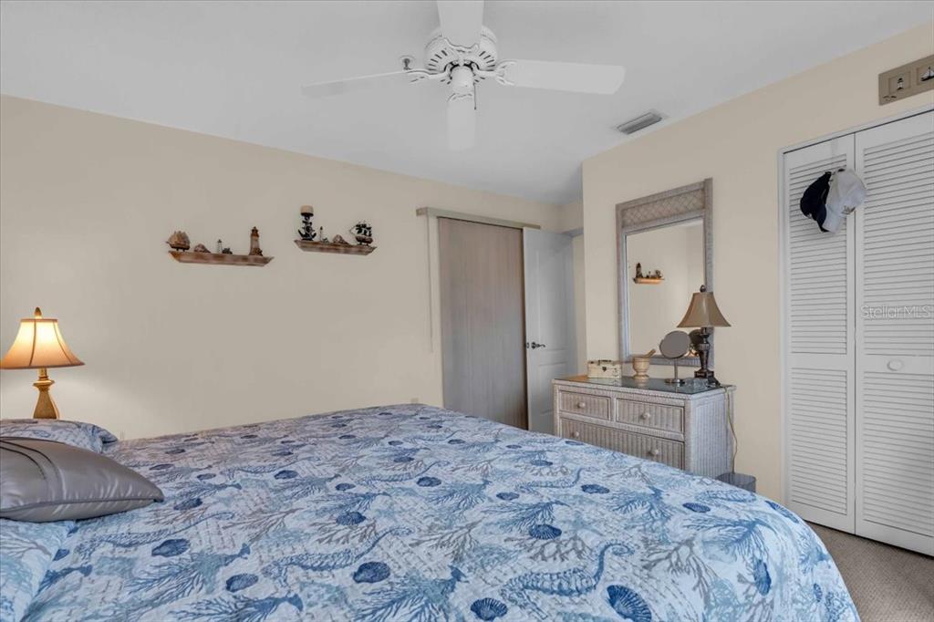 6713 Stone River Road, Unit 206 Bradenton, FL 34203 - Photo 23 of 58 a bedroom with a bed and a dresser