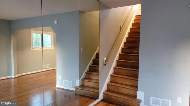 a view of entryway and hall with wooden floor