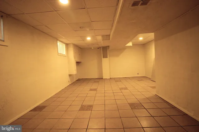 a view of a livingroom with an empty space and a window