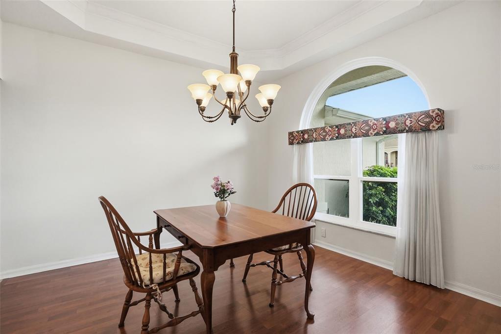 14228 Presteign Lane Spring Hill, FL 34609 - Photo 34 of 89 a view of a dining room with furniture wooden floor and chandelier