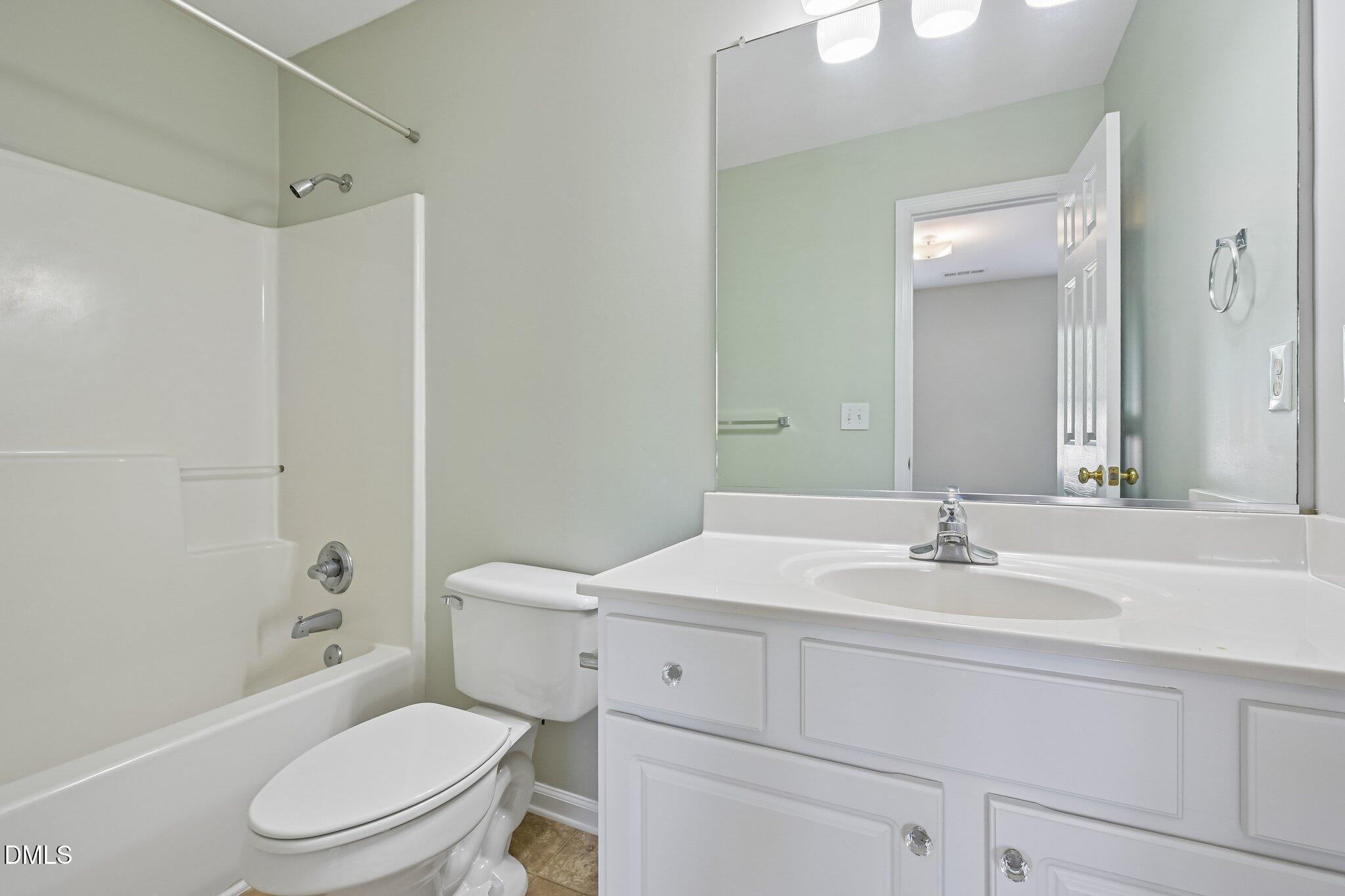 278 South Raleigh Street Angier, NC 27501 - Photo 25 of 35 a bathroom with a sink toilet vanity tub and shower
