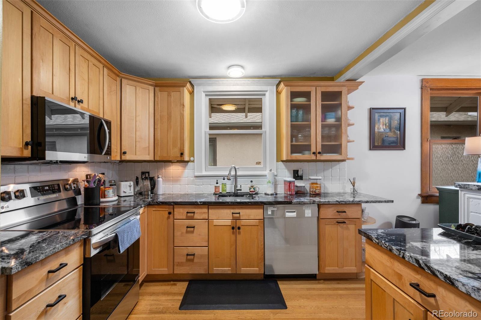 1136 Cook Street Denver, CO 80206 - Photo 14 of 42 a kitchen with a sink stove and microwave