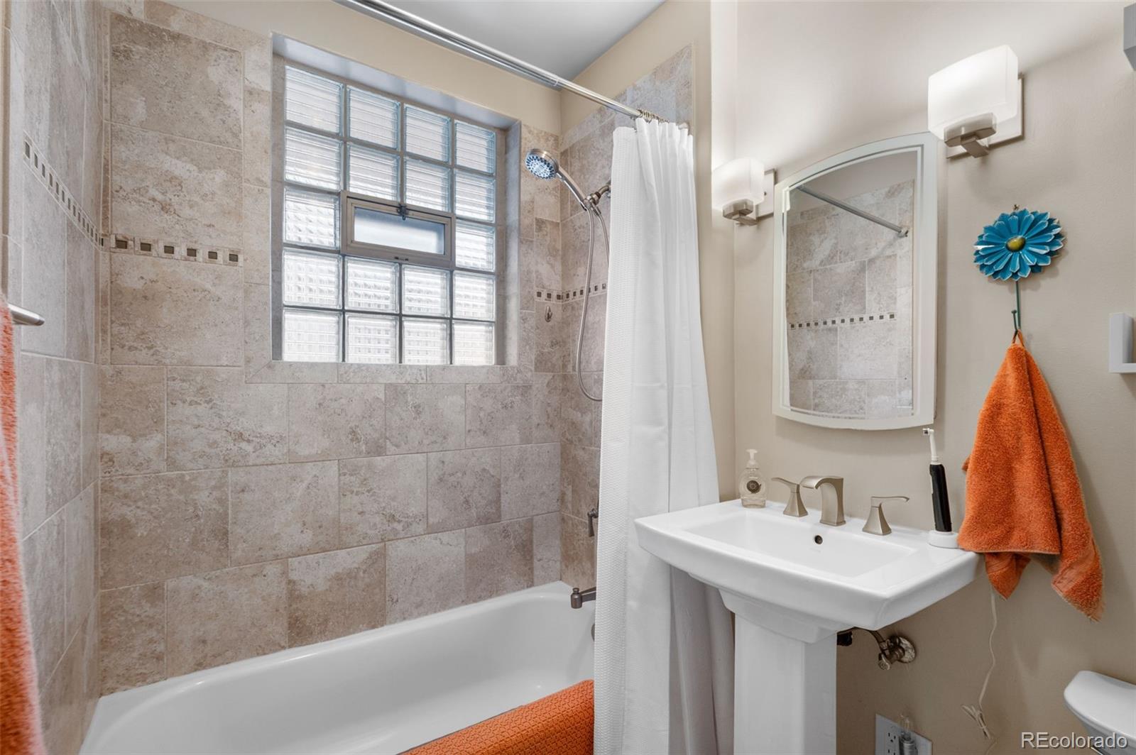 1136 Cook Street Denver, CO 80206 - Photo 18 of 42 a bathroom with a sink shower and a bathtub