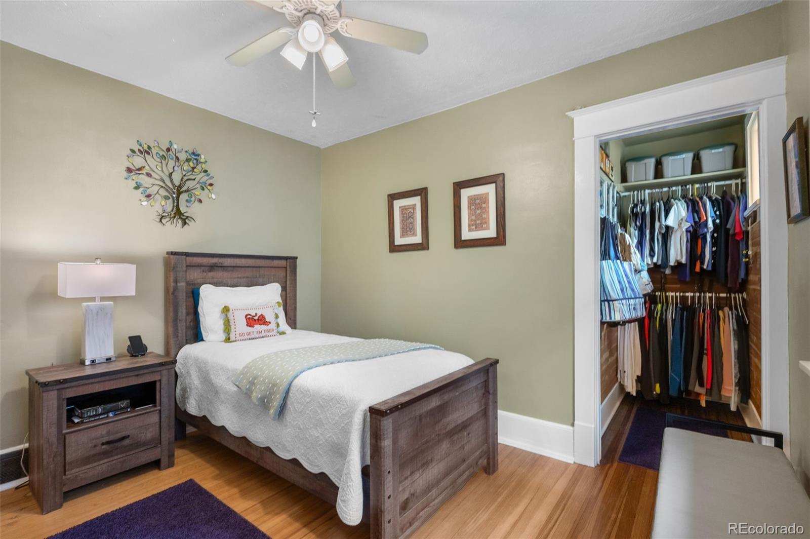 1136 Cook Street Denver, CO 80206 - Photo 20 of 42 a bedroom with a bed and a chandelier