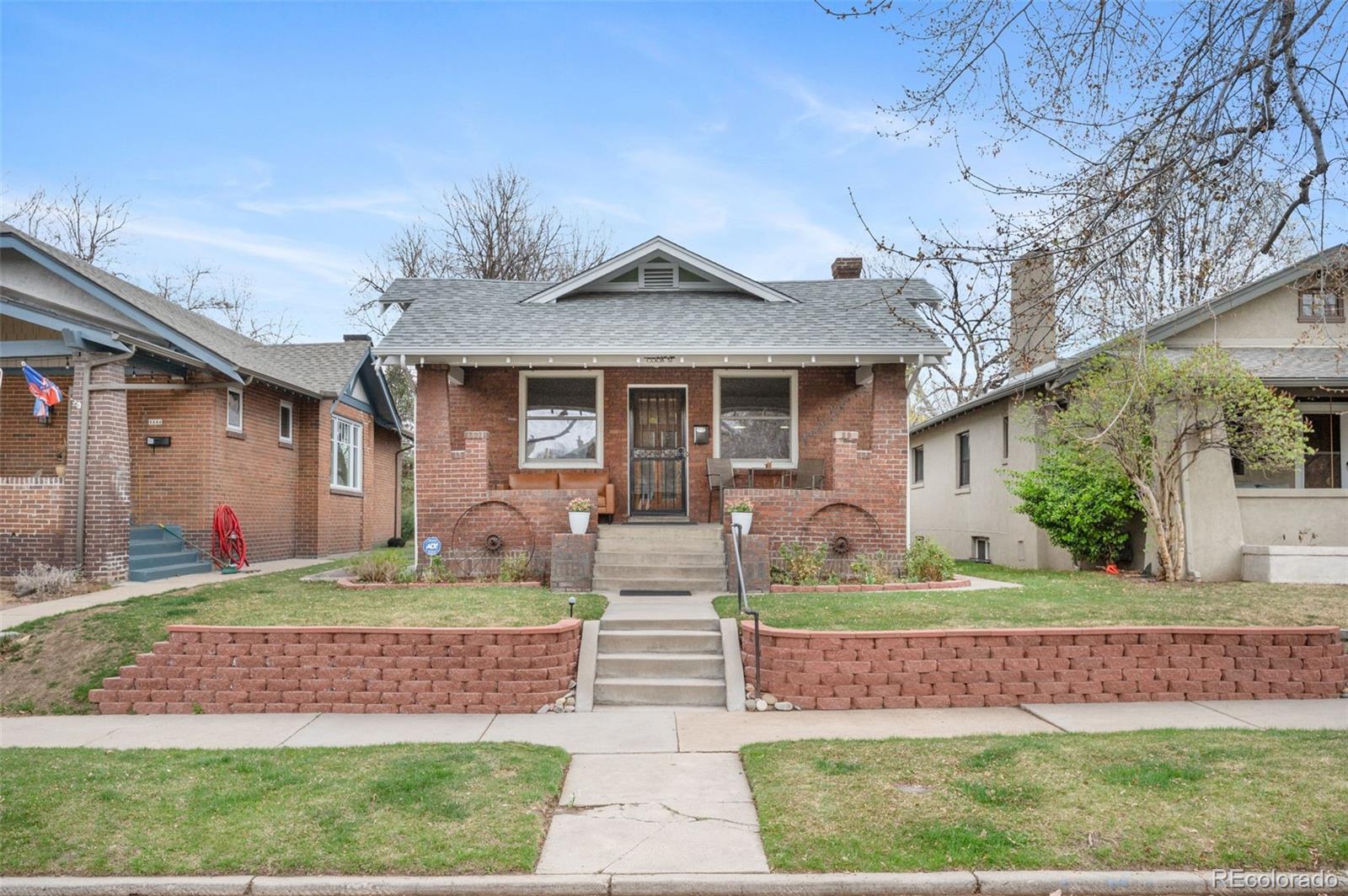 1136 Cook Street Denver, CO 80206 - Photo 2 of 42 a front view of a house with garden