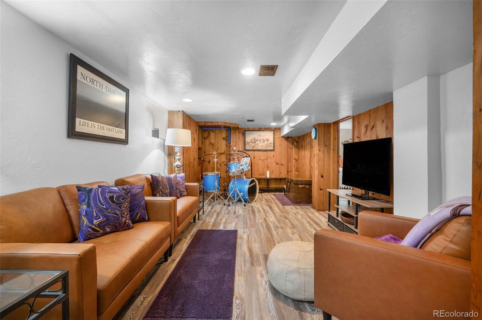 1136 Cook Street Denver, CO 80206 - Photo 22 of 42 a living room with furniture and a flat screen tv