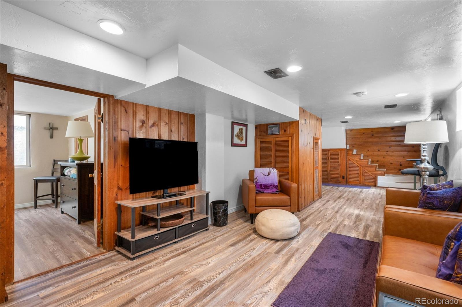 1136 Cook Street Denver, CO 80206 - Photo 23 of 42 a living room with furniture and a flat screen tv