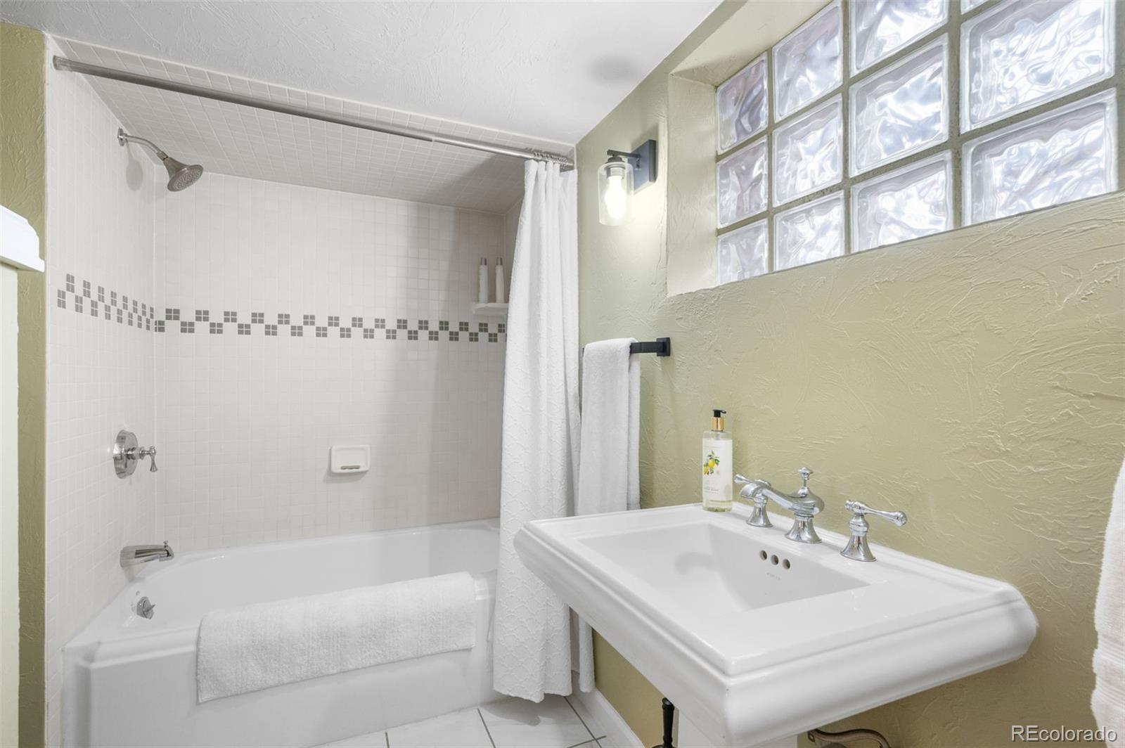 1136 Cook Street Denver, CO 80206 - Photo 26 of 42 a bathroom with a sink and a mirror