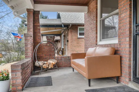 a building outdoor space with patio furniture and potted plants