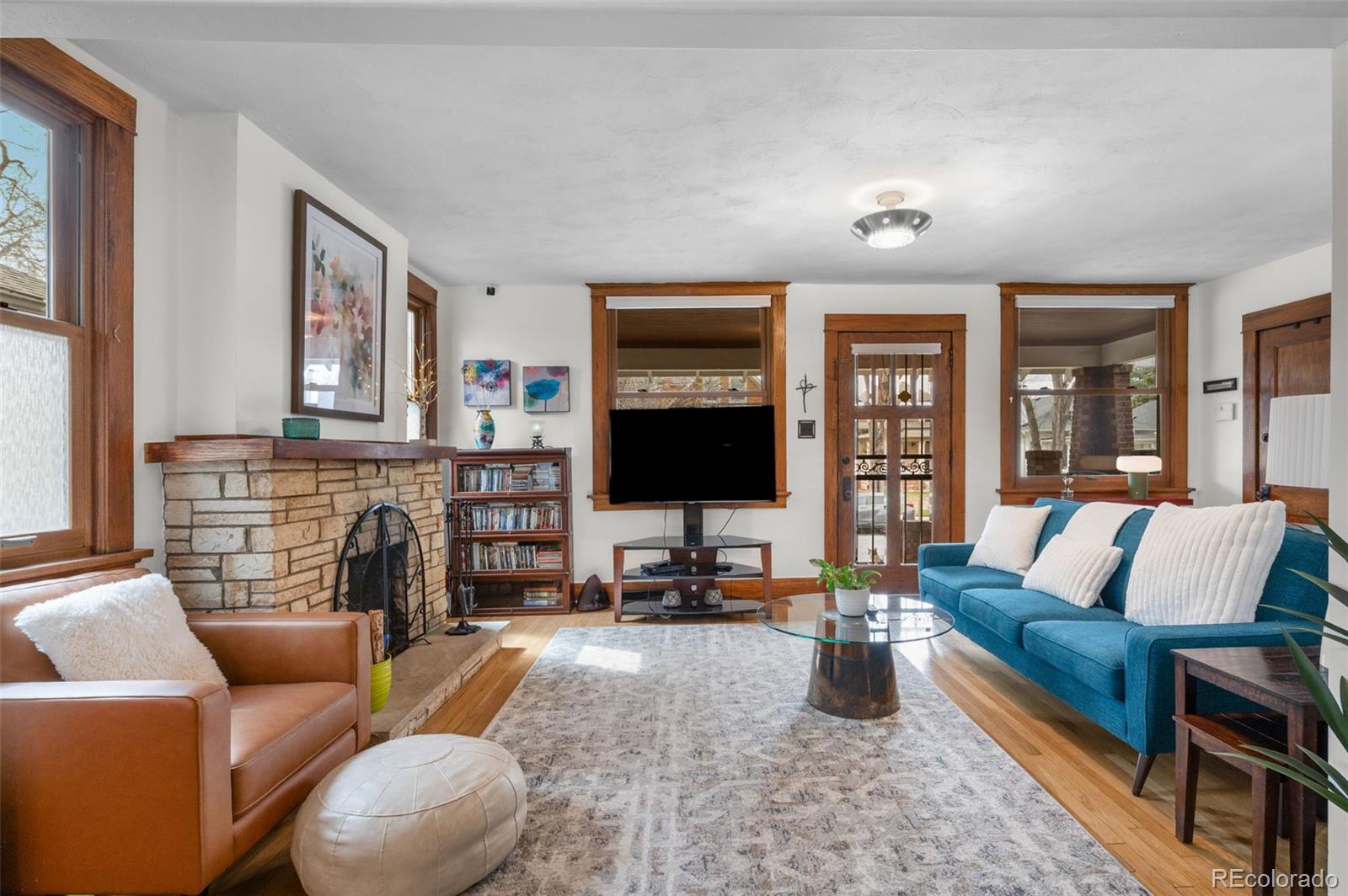 1136 Cook Street Denver, CO 80206 - Photo 7 of 42 a living room with fireplace furniture and a flat screen tv