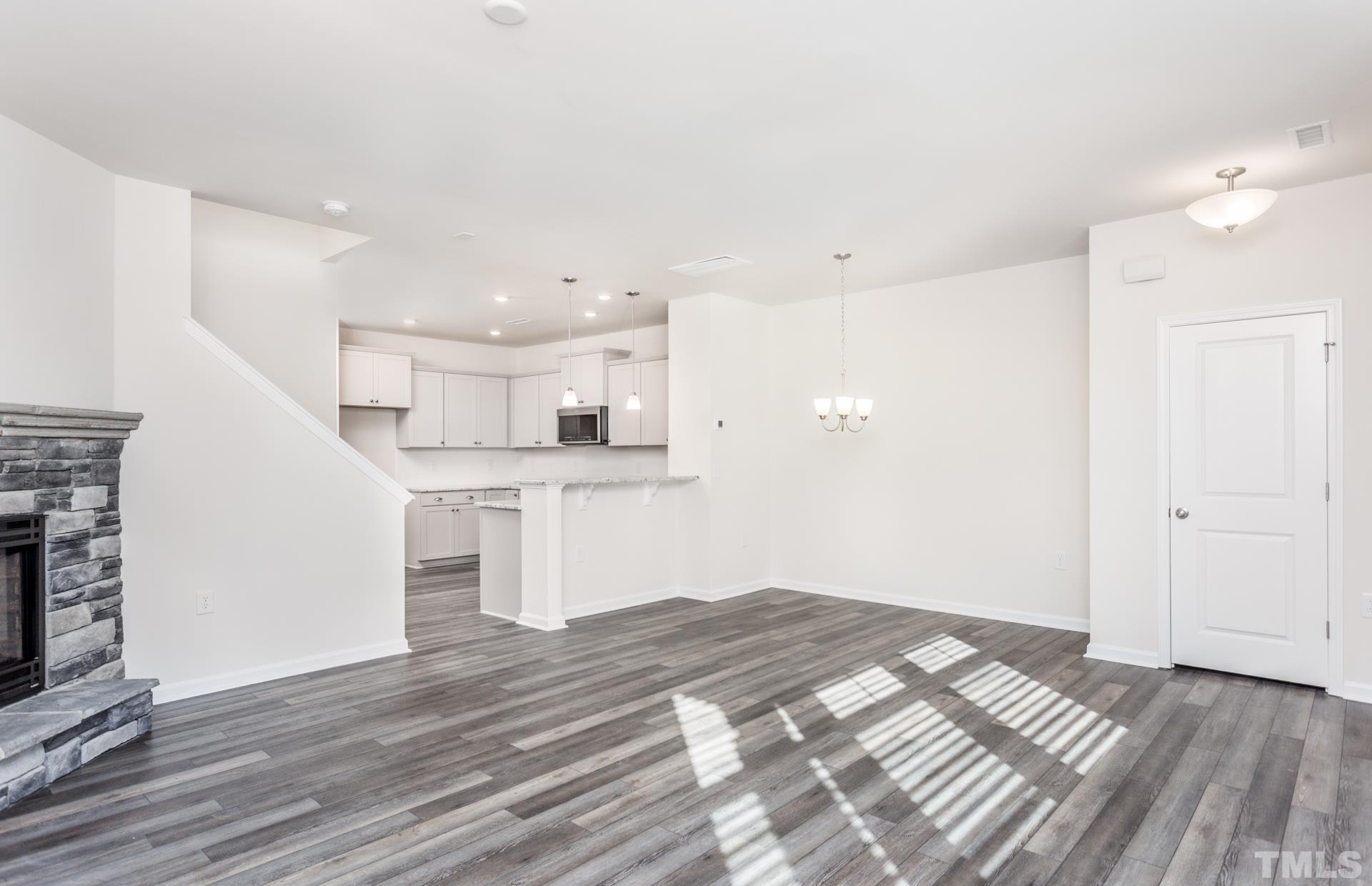 5714 Volos Avenue Raleigh, NC 27603 - Photo 12 of 20 a view of a kitchen with wooden floor and a kitchen