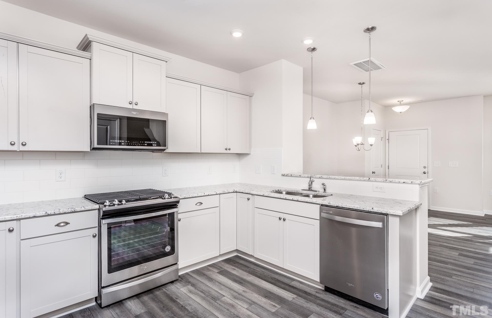 5714 Volos Avenue Raleigh, NC 27603 - Photo 14 of 20 a kitchen with a sink stove and microwave