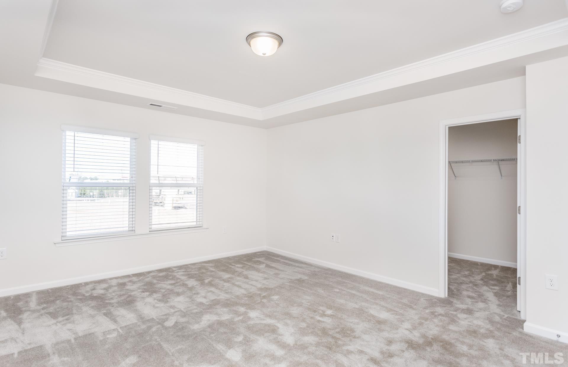 5714 Volos Avenue Raleigh, NC 27603 - Photo 4 of 20 an empty room with a empty space and windows