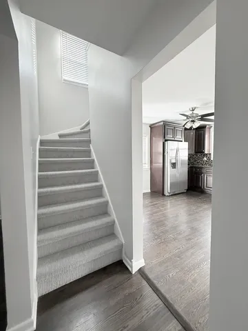 a view of entryway and hall with wooden floor