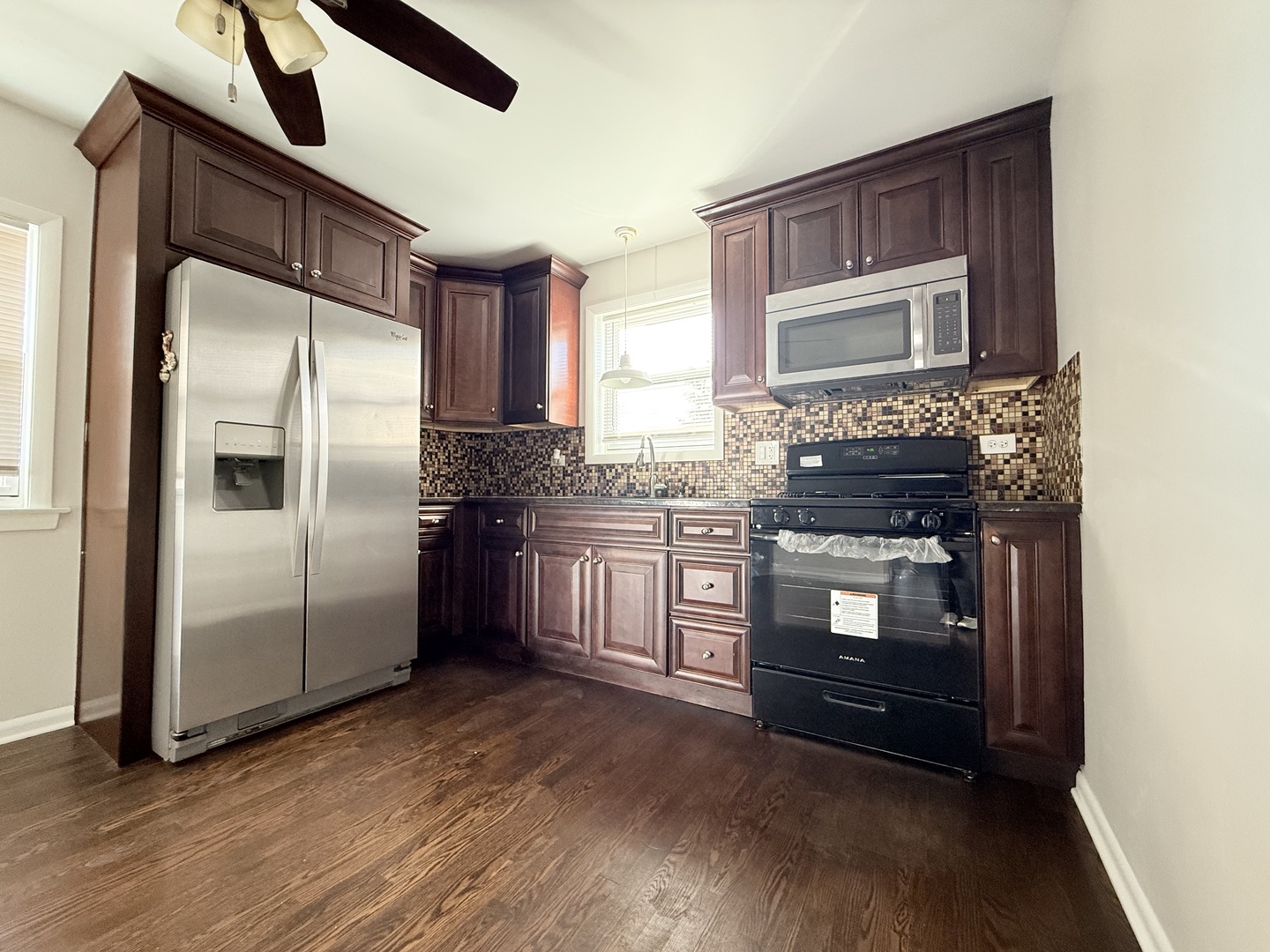 5850 South Neva Avenue Chicago, IL 60638 - Photo 6 of 17 a kitchen with stainless steel appliances granite countertop a refrigerator a stove and a microwave oven
