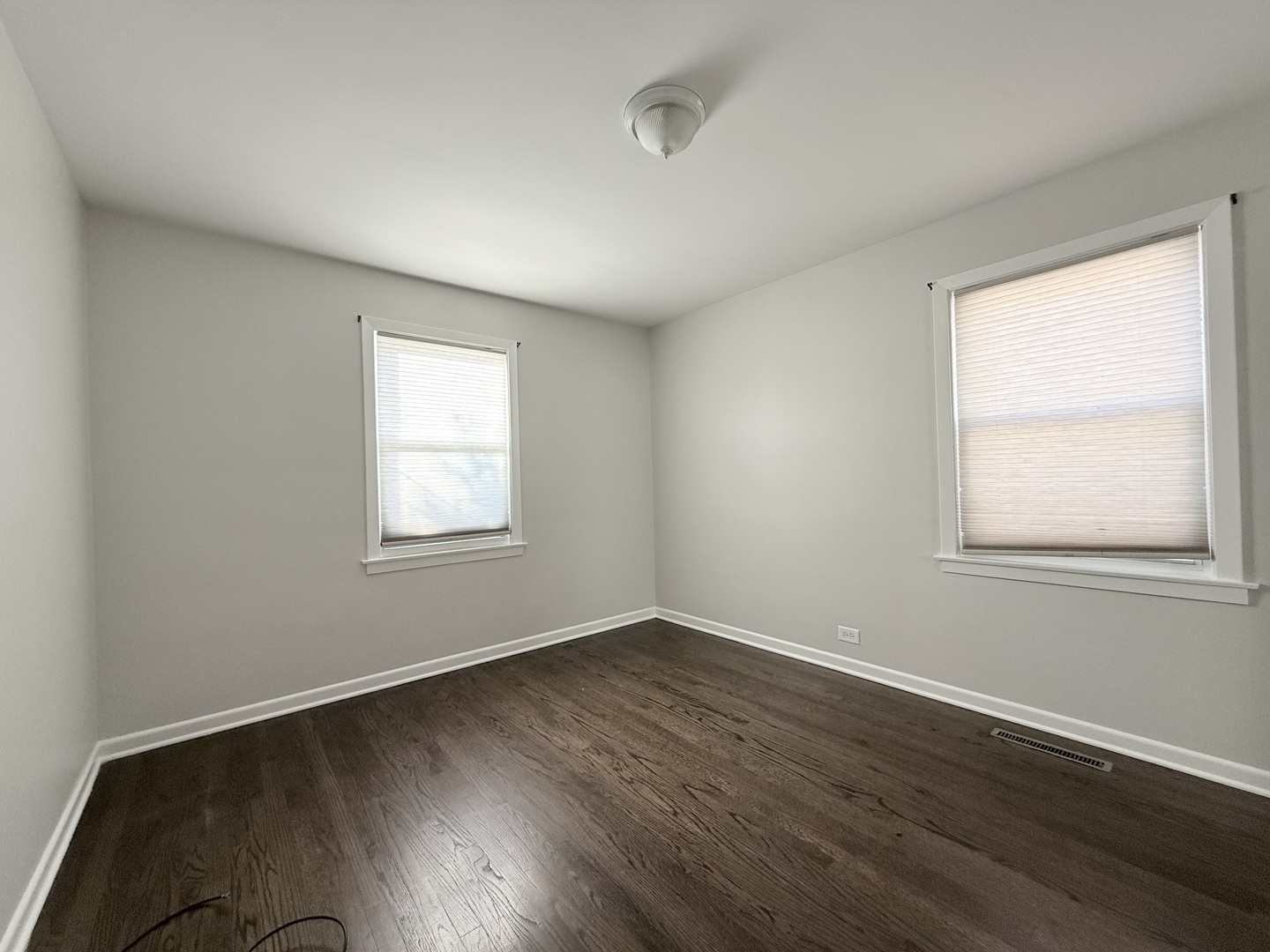 5850 South Neva Avenue Chicago, IL 60638 - Photo 9 of 17 an empty room with wooden floor and windows