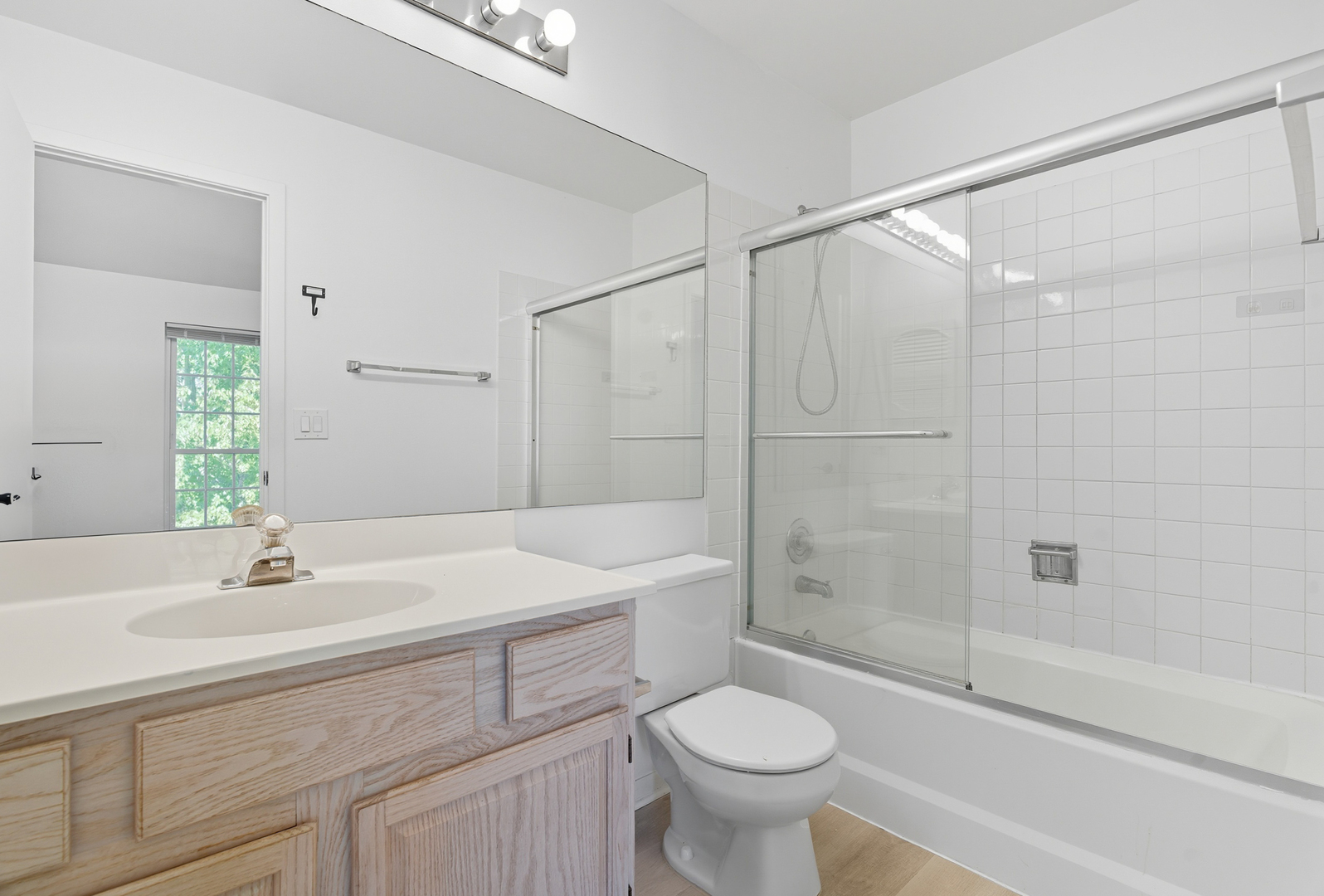519 Woodcrest Drive, Unit 519 Mundelein, IL 60060 - Photo 13 of 21 a bathroom with a sink toilet a mirror and shower