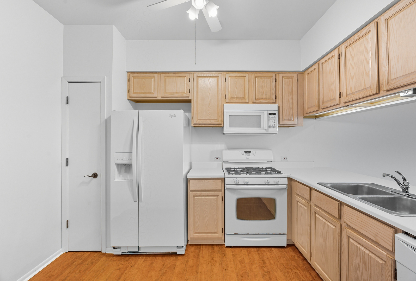 519 Woodcrest Drive, Unit 519 Mundelein, IL 60060 - Photo 5 of 21 a kitchen with white cabinets and white appliances