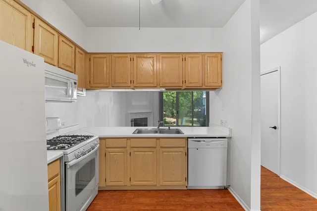 a kitchen with a sink stove and cabinets