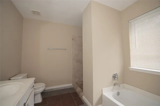 a bath room with a toilet a sink and a bath tub