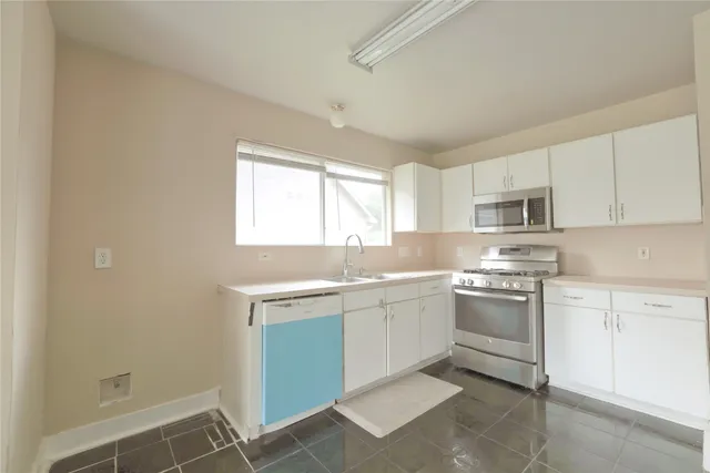 a kitchen with a sink cabinets and window