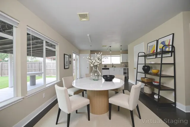 a dining room with furniture and window