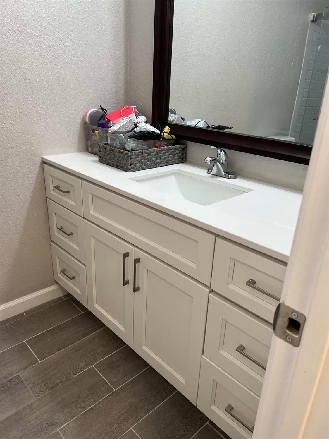8603 Acapulco Way Stockton, CA 95210 - Photo 17 of 39 a bathroom with a sink and a mirror