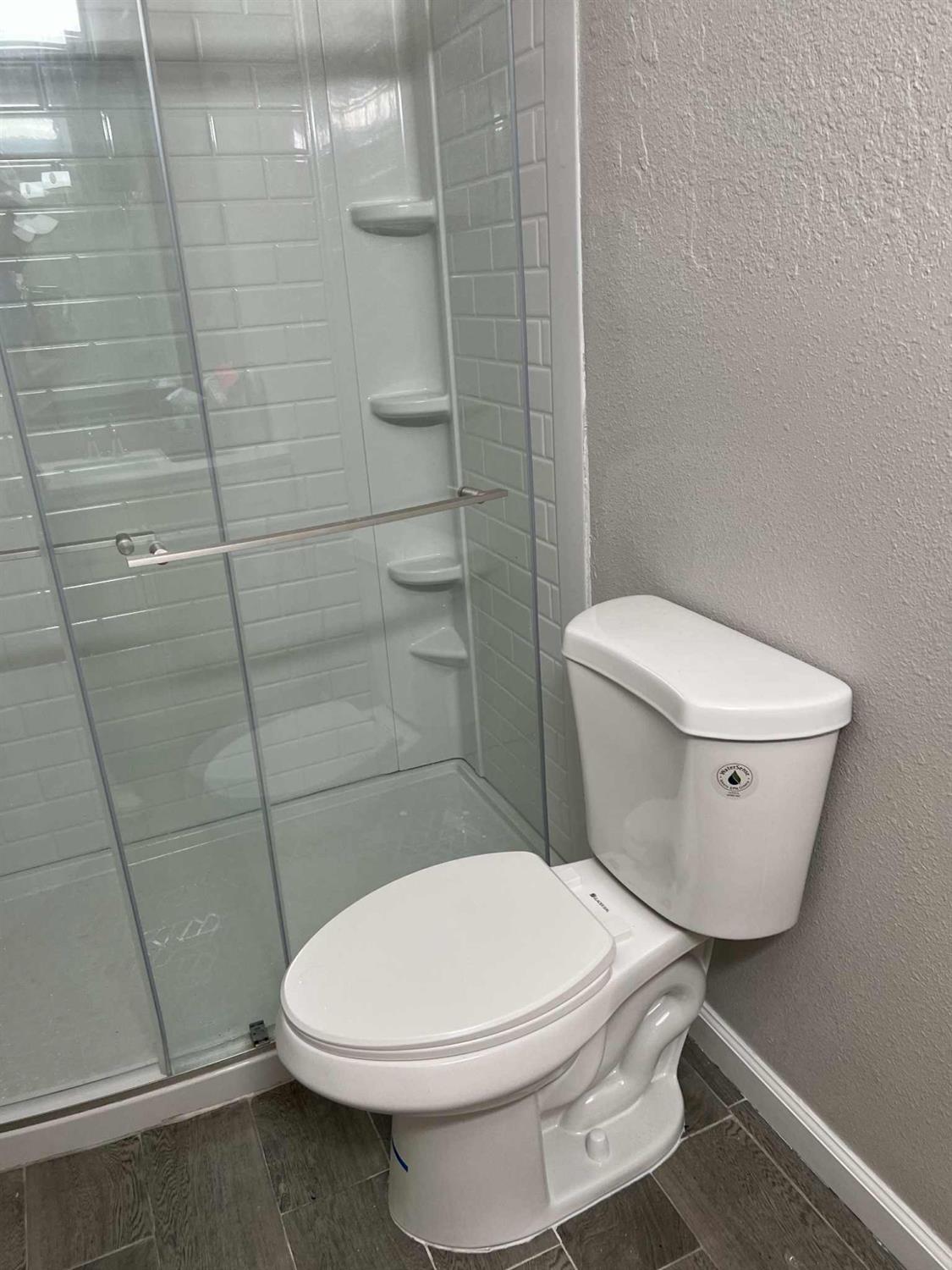 8603 Acapulco Way Stockton, CA 95210 - Photo 18 of 39 a white toilet sitting next to a shower