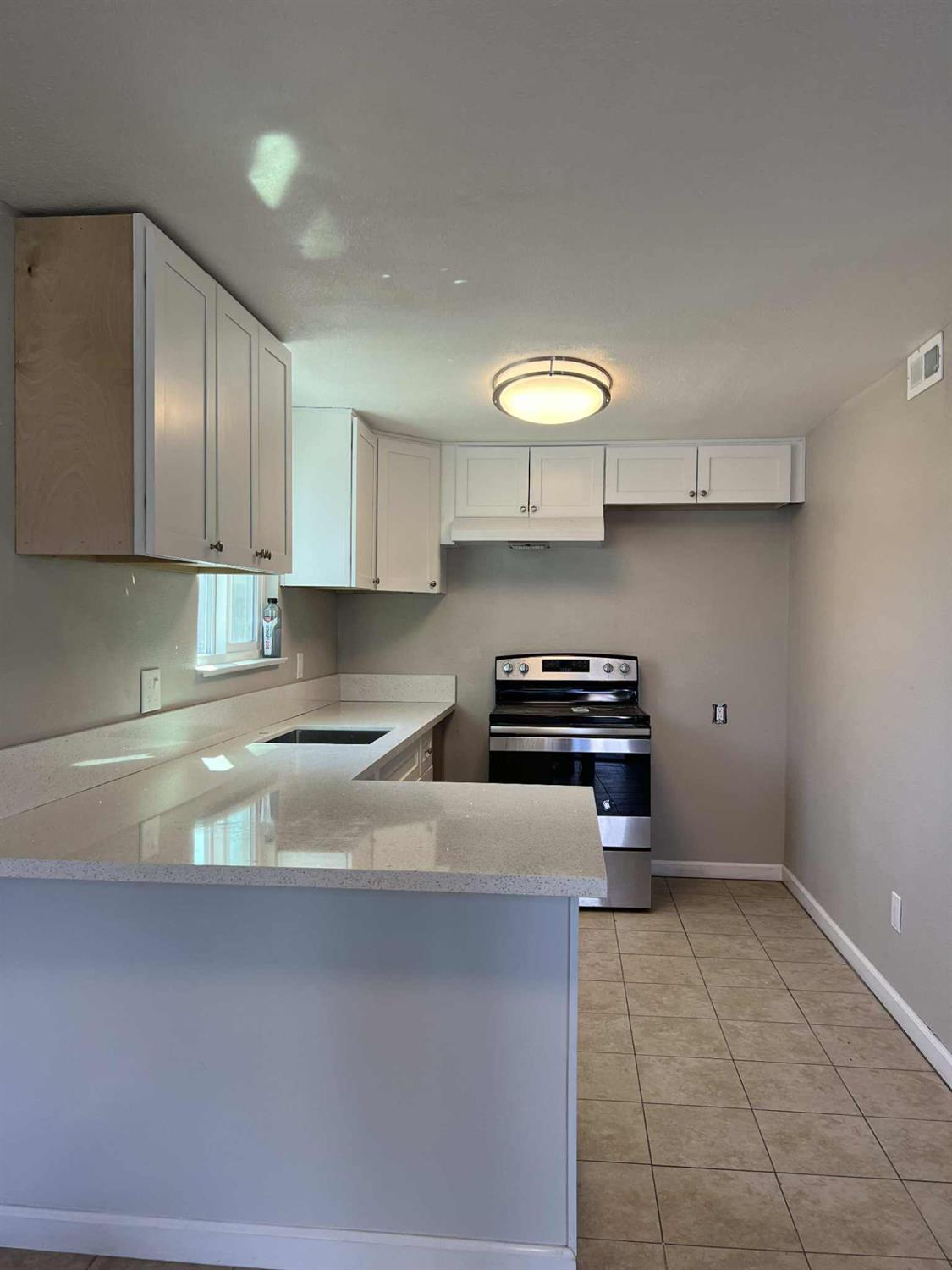 8603 Acapulco Way Stockton, CA 95210 - Photo 4 of 39 a kitchen with a sink a stove and cabinets