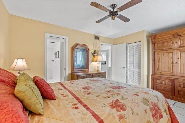a bathroom with a granite countertop toilet a sink and a mirror