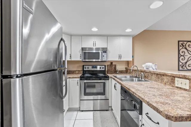 a kitchen with a sink cabinets and a wooden floor