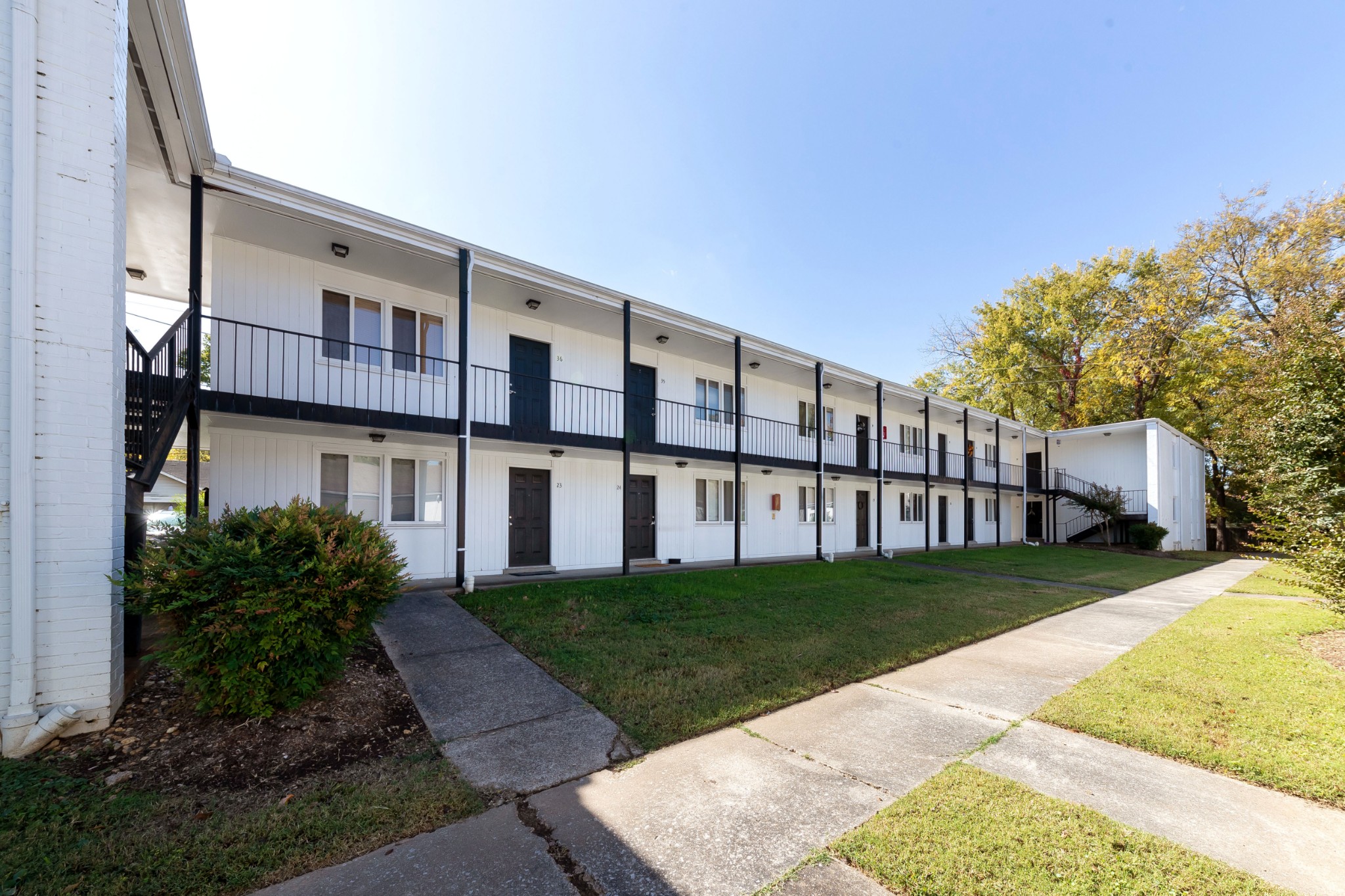 802 East Main Street, Unit 23 Murfreesboro, TN 37130 - Photo 2 of 21 a view of a white house with a big yard and large trees