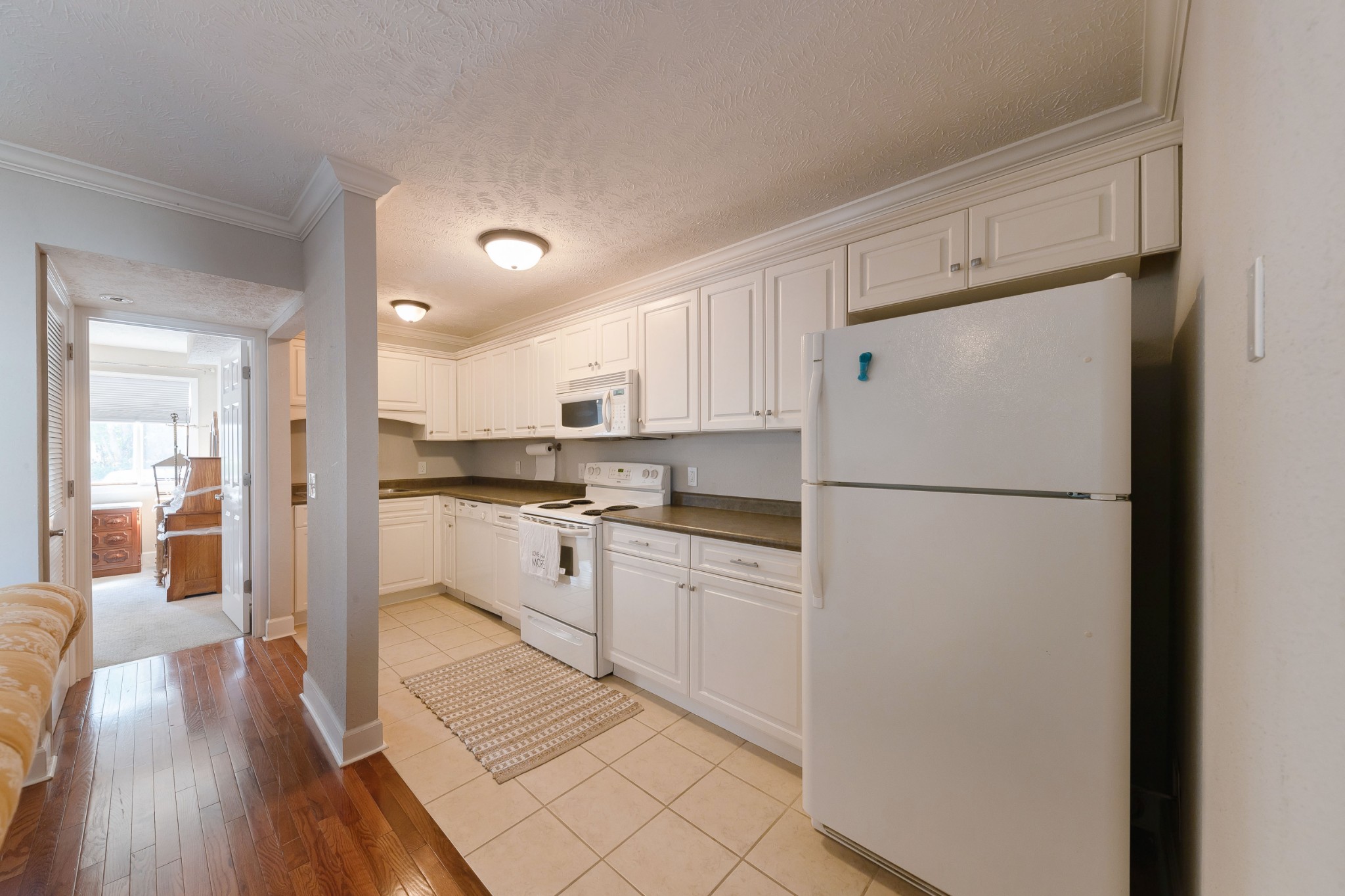 802 East Main Street, Unit 23 Murfreesboro, TN 37130 - Photo 8 of 21 a kitchen with white cabinets and white appliances